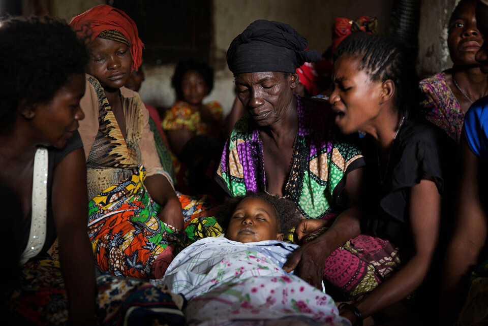 Moren Josephina Kalunda (t.h.) gråter mens kvinnene i huset holder datteren Nsensele Sifas (4). Bestemoren som barnet ble oppkalt etter ser på. Foto: James Oatway / Unicef