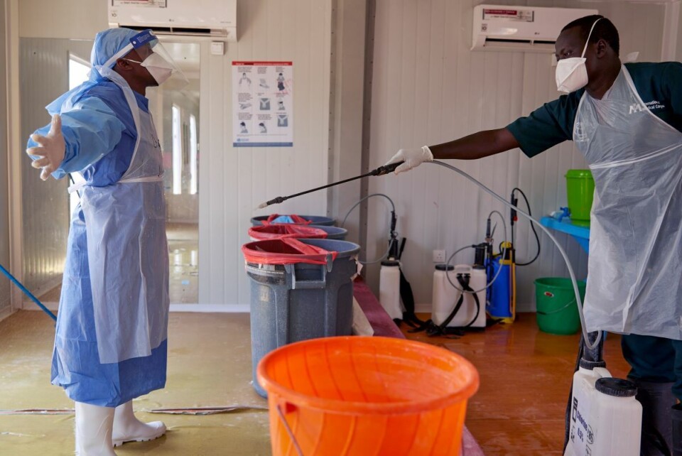 En lege fra organisasjonen International Medical Corps blir desinfisert ved et offentlig sykehus i Juba. Nå kan både helsearbeidere og andre glede seg over at dagliglivet gradvis vender tilbake. Restauranter og barer er delvis gjenåpnet og det er lettelser i portforbudet. Foto: Alex McBride / AFP / NTB scanpix
