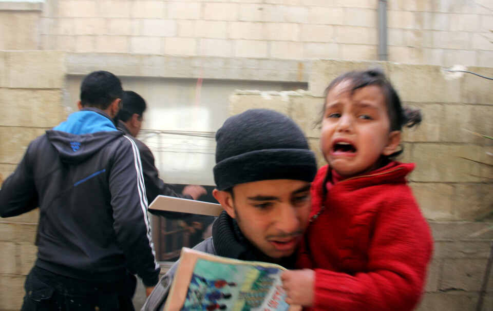 En liten jente gråter i armene til en slektning etter nok et bombeangrep fra styrker lojale til Syrias president Bashar al-Assad. Bildet ble tatt 7. februar i nordlige deler av Homs. Foto: REUTERS / Stringer / Scanpix
