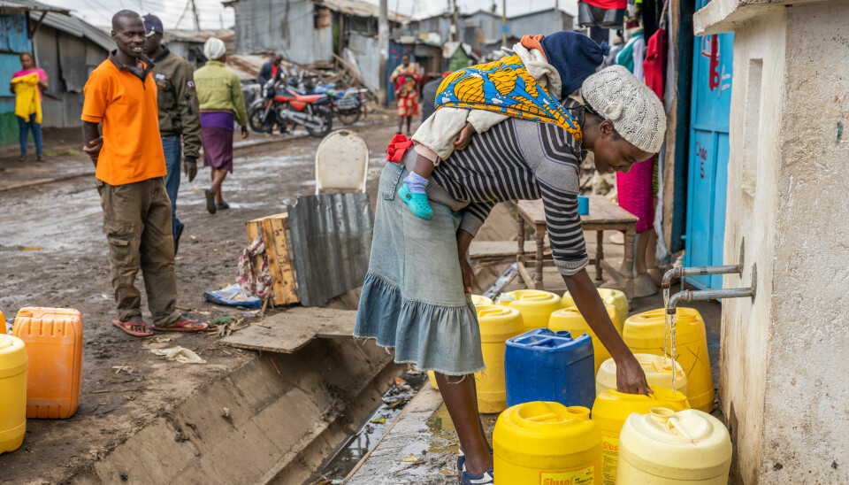 Trebarnsmoren Martha Wagechi (24) henter vann ved den nye vannposten der vann blitt gratis for innbyggerne. Det nye utviklingsprosjektet skal gi nye veier, strøm, gratis vann og gode sanitære forhold til Mukuru og flere steder i slummen begynner innsatsen å merkes.