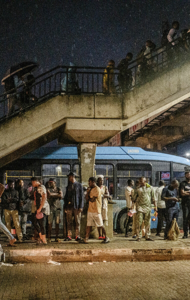 LAGOS, NGA - June 7, 2023: Workers seeking shelter from the rain in Iyana Oworo, Lagos Mainland, Nigeria. Lagos, a city that never sleeps, is known for its hustle and bustle. Everyone in the city is striving to survive. CREDIT: Taiwo Aina