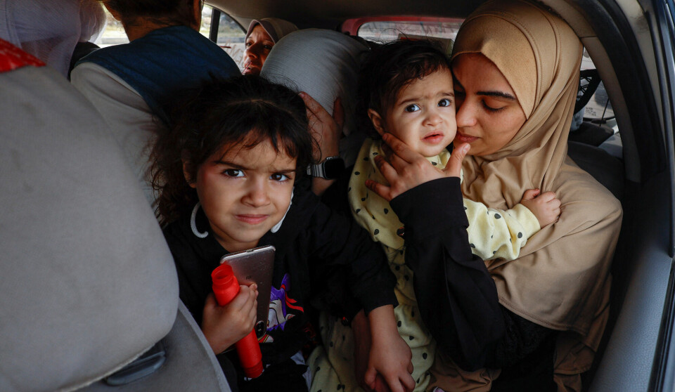 Palestinian woman Raghda Abu Marasa, who fled to the southern part of the enclave after Israel's call for more than 1 million civilians in northern Gaza to move south amid the ongoing Israel-Hamas conflict, sits in a car with her children and family members as they return to their home in Gaza City, in Khan Younis in the southern Gaza Strip, October 17, 2023. Abu Marasa said they decided to return to their home as they found no safe place to stay at in southern Gaza.  REUTERS/Mohammed Salem