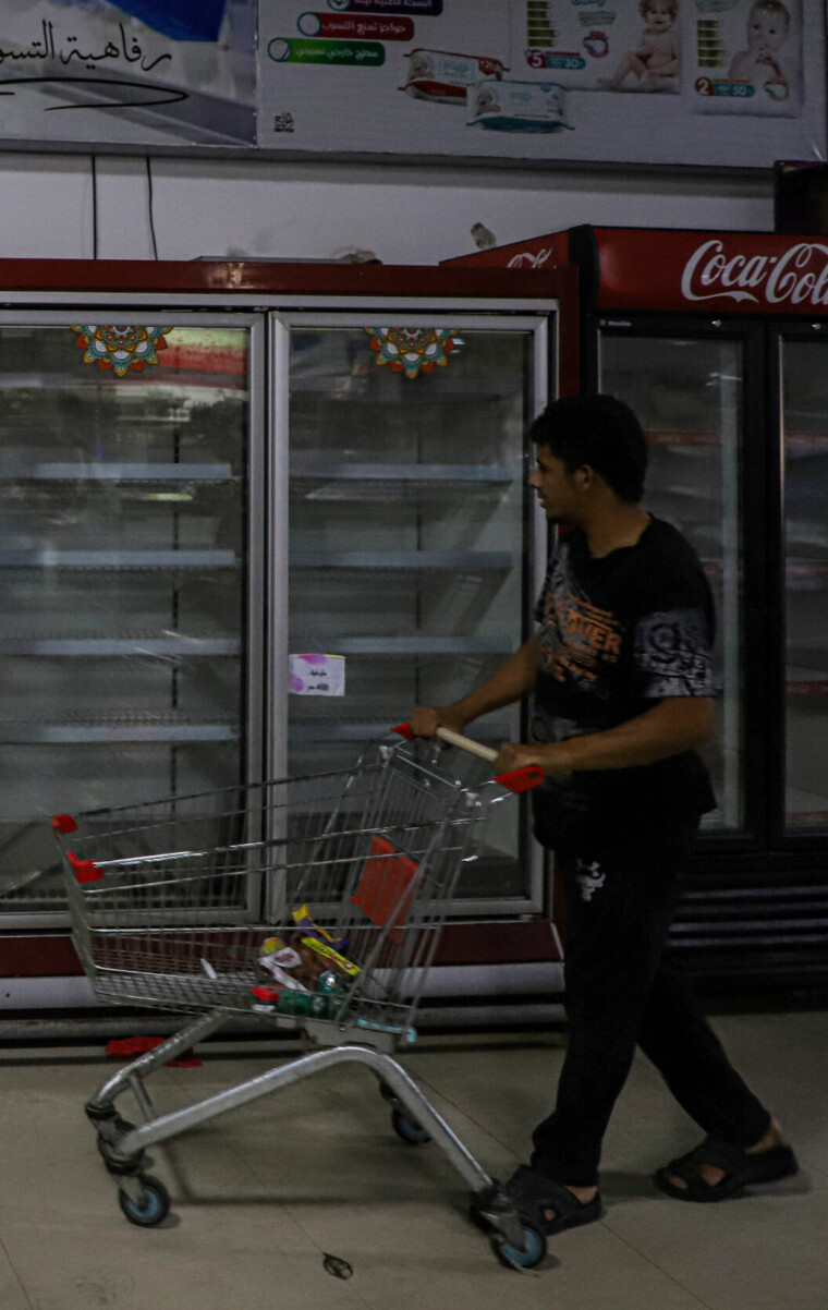 (231102) -- GAZA, Nov. 2, 2023 (Xinhua) -- A man shops at a supermarket in the southern Gaza Strip city of Khan Younis, on Nov. 2, 2023. The Palestinian Islamic Resistance Movement (Hamas) launched a surprise attack on Israel on Oct. 7, firing thousands of rockets and infiltrating Israeli territory, to which Israel responded with massive airstrikes and punitive measures, including a siege on the enclave with supplies of water, electricity, fuel, and other necessities being cut off. (Photo by Rizek Abdeljawad/Xinhua)
