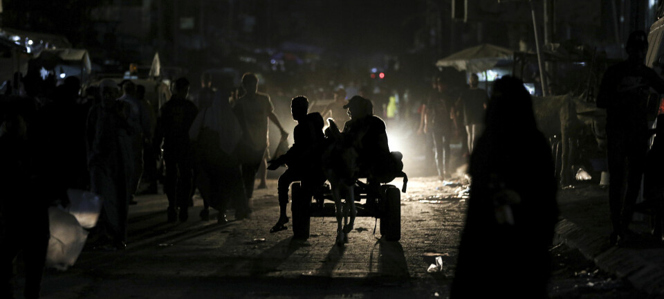 People walk in the dark, as power has been out since the beginning of the conflict between Israel and Hamas, in Khan Younis, in the southern Gaza Strip, Nov. 2, 2023. (Yousef Masoud/The New York Times)