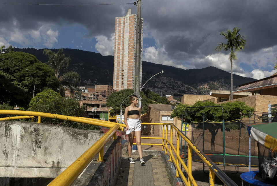 En ung kvinne krysser en bro nær Moravia kultur- og utviklingssenter som ble opprettet i 2008. Morovia var en av de vanskeligstilte bydelene i Medellín, men kultursenteret og flere andre initiativ har bidratt til at bydelen har blomstret opp.