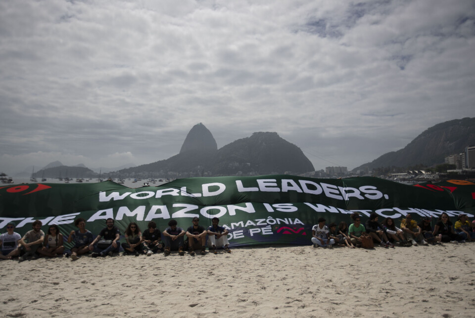 Aktivister fra bevegelsen «Amazônia de Pé» på Botafogo-stranden i Rio de Janeiro med et banner med påskriften «Verdens ledere: Amazonas ser på» under en demonstrasjon mot statslederne som deltar på G20-toppmøtet.