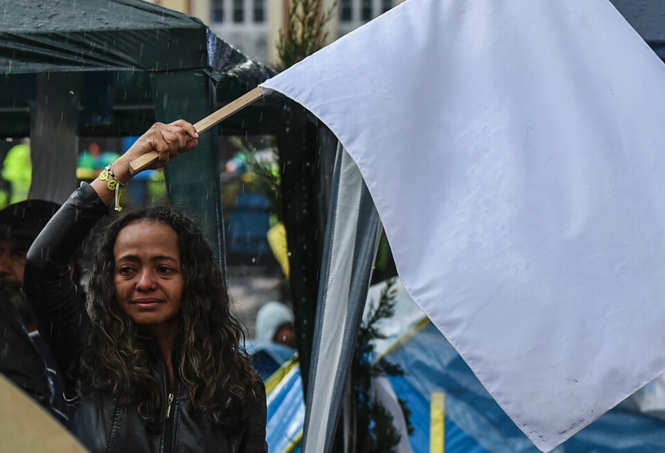 En kvinne i Bogotá, Colombia, holdt opp et hvitt flagg etter at Colombias regjering og FARC-geriljaen inngikk en fredsavtale i 2016. Freden i Colombia er avgjørende for å møte landets store utviklingsutfordringer.