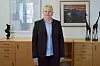 Anne Sofie Bjelland står på kontoret sitt i Lilongwe, omgitt av møbler, kunst og skulpturer.